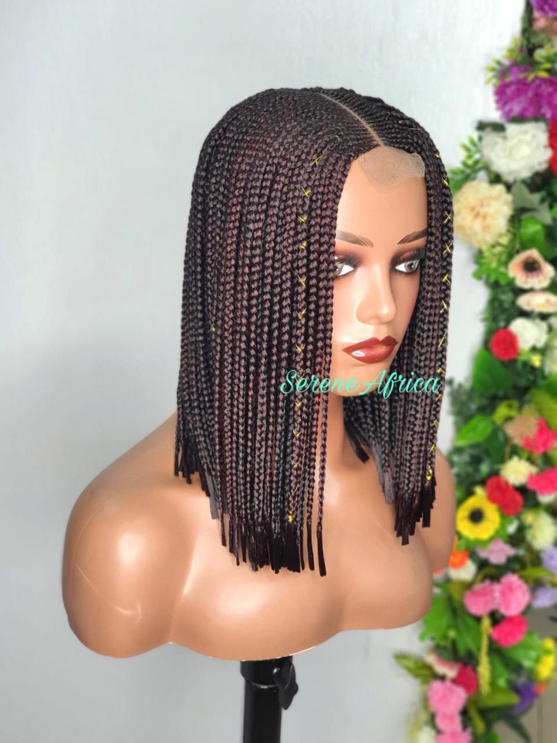 Side view dark brown box braid wig with loose ends 12 inches on mannequin head natural braided wig
