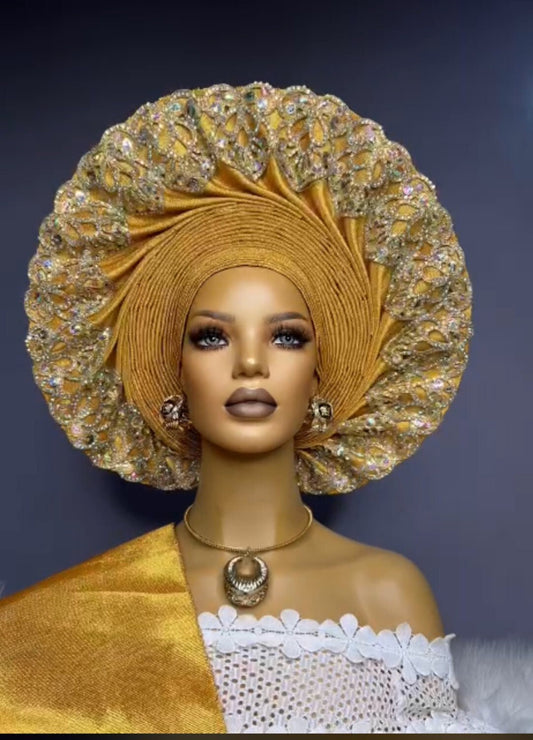 Front view gold embellished asooke auto gele pre tied ready to wear african headwrap for traditional wedding on a mannequin