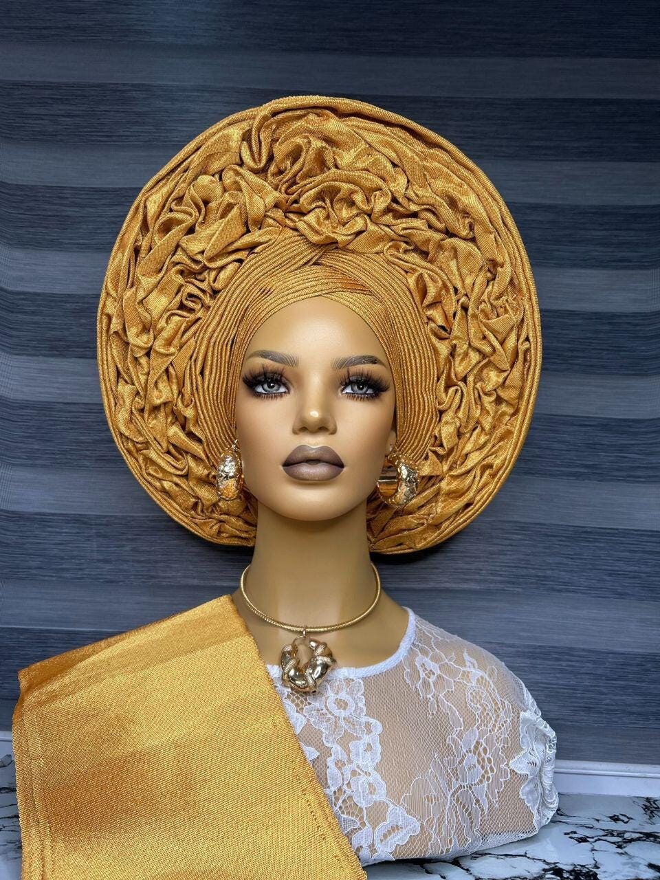 Front view Asooke auto gele ready to wear nigerian bridal headwrap on a mannequin