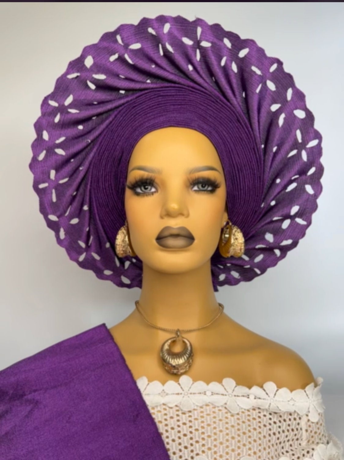 Elegant purple ready-to-wear gele headwrap styled on mannequin for bridal and party wear
