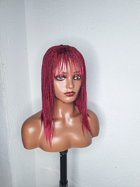 Side view burgundy box braid wig with bangs on mannequin head ready to wear braided wig