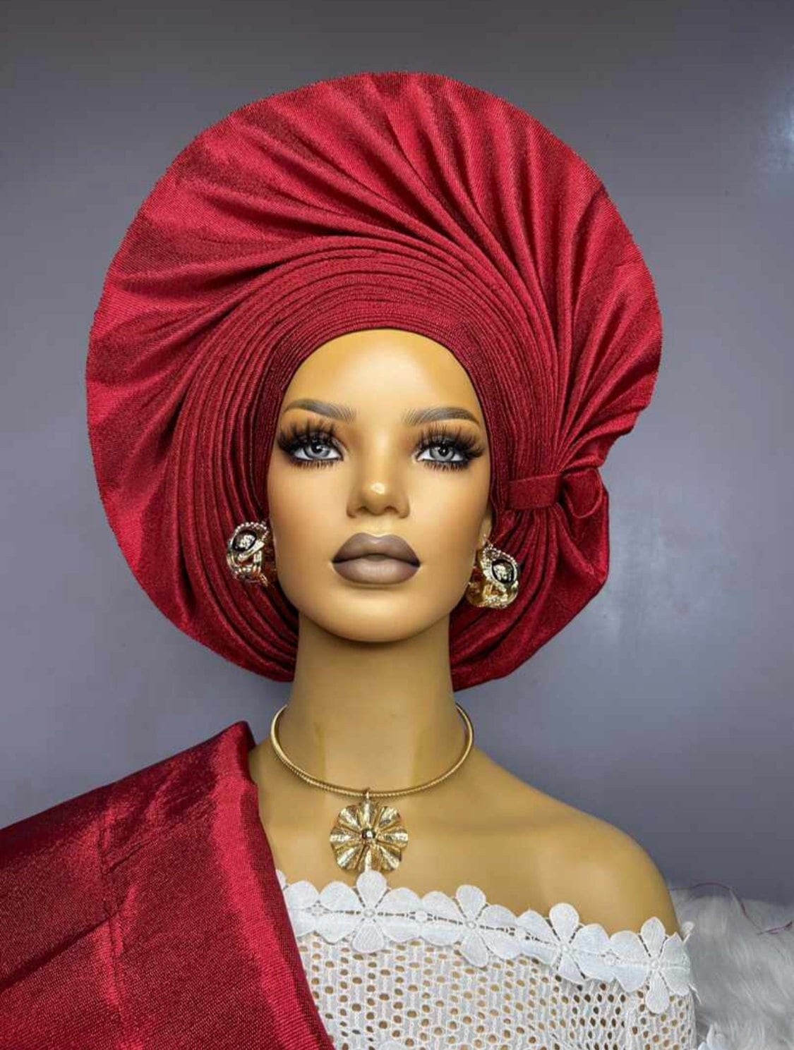 Wine red autogele headwrap with pleated fan design on mannequin