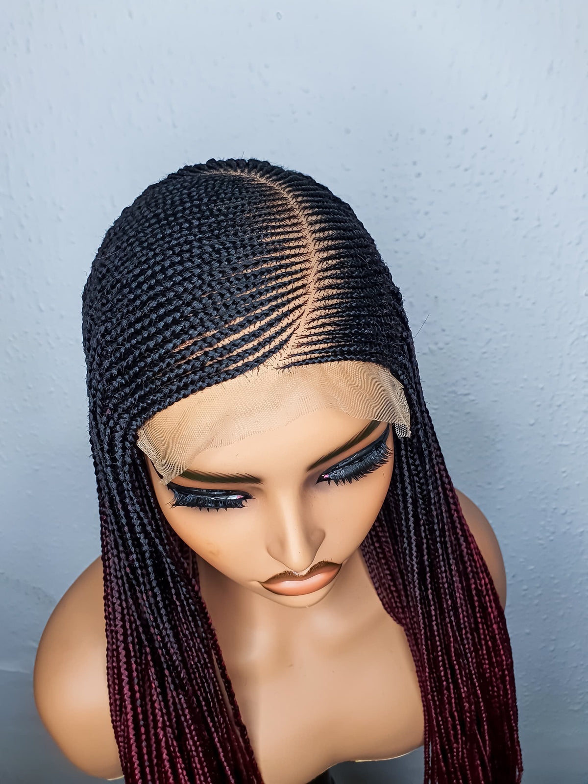 Close-up of C-cut cornrows and 5x5 lace closure on ombré braided wig