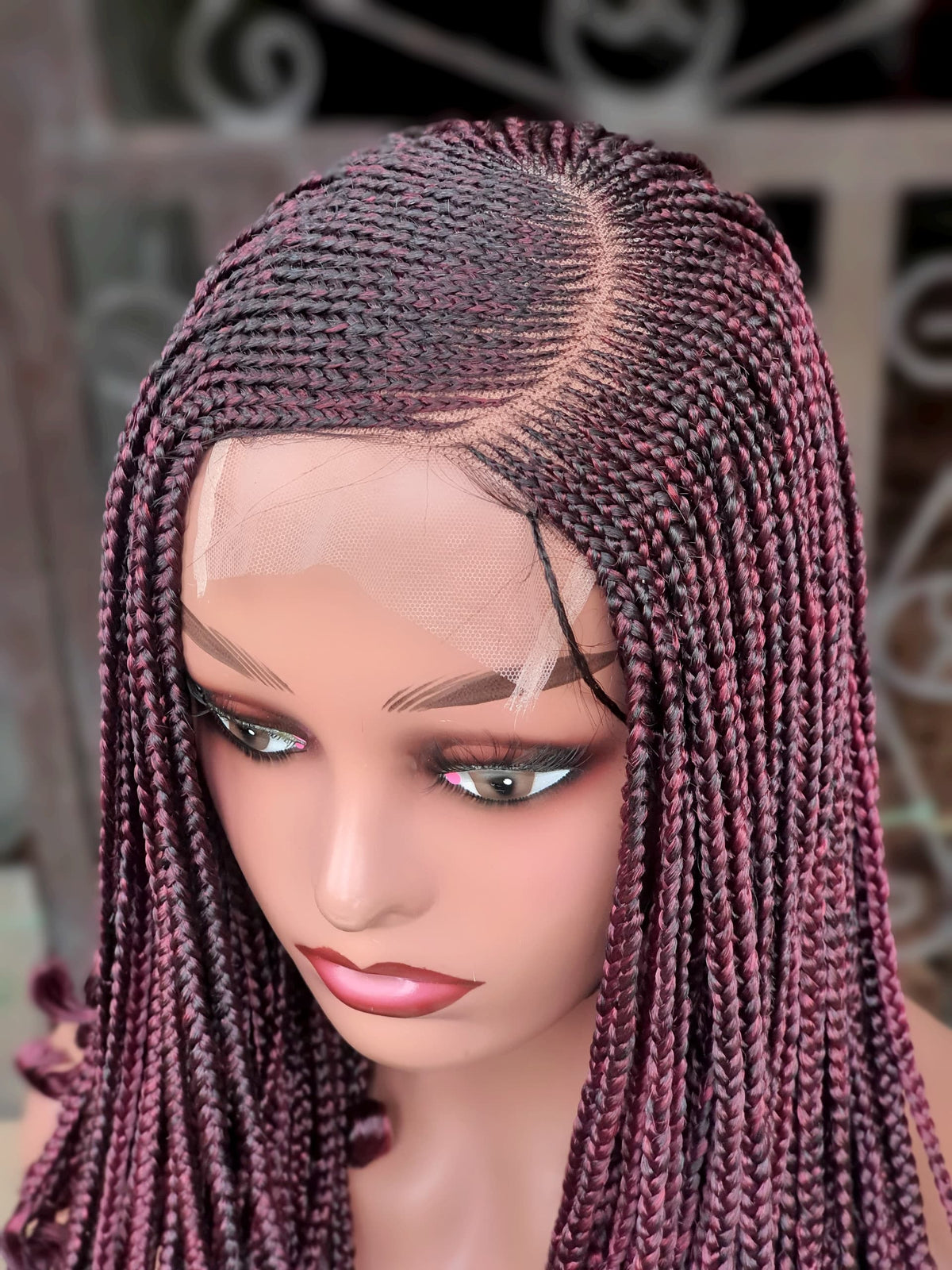 Close-up of burgundy cornrows, side part and 5x5 lace closure