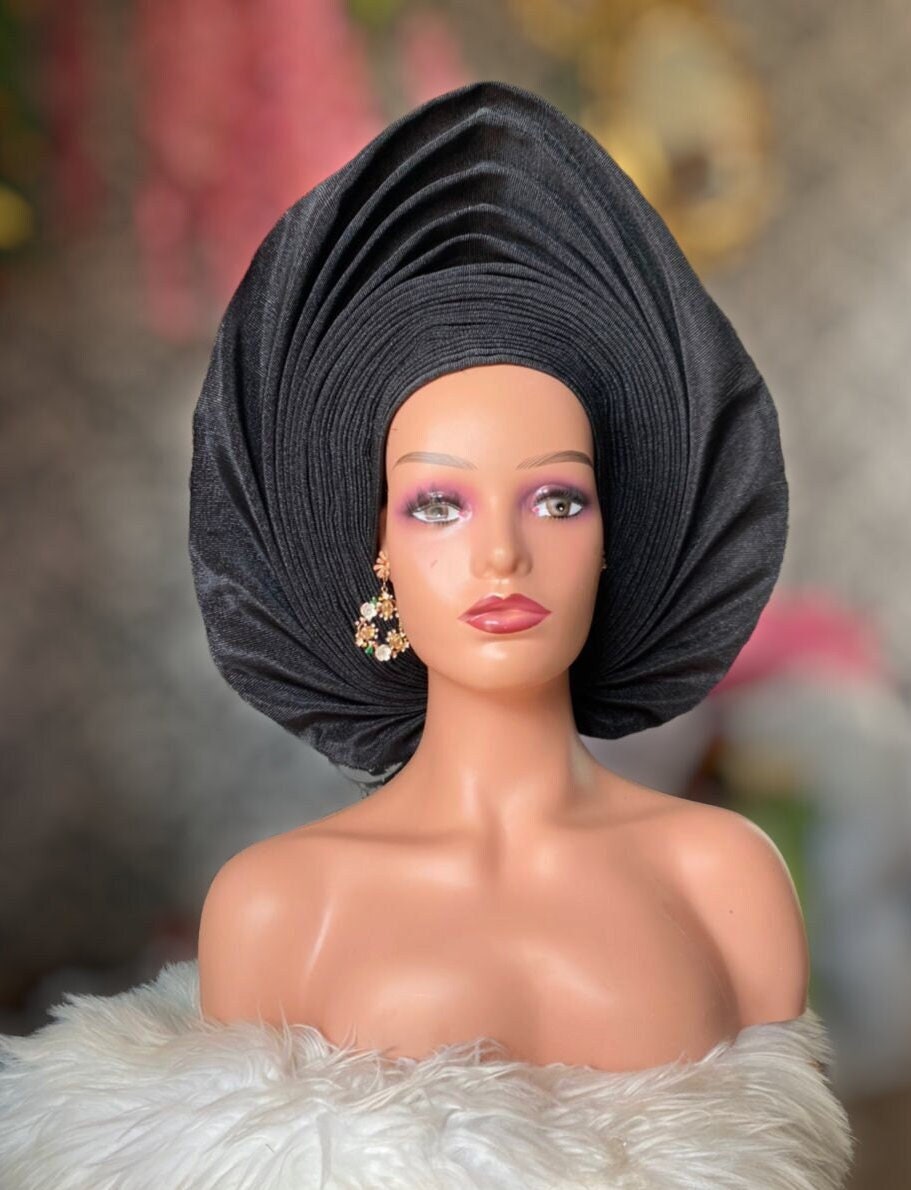Front view black asooke auto gele pre tied ready to wear nigerian bridal headwrap for traditional wedding on a mannequin