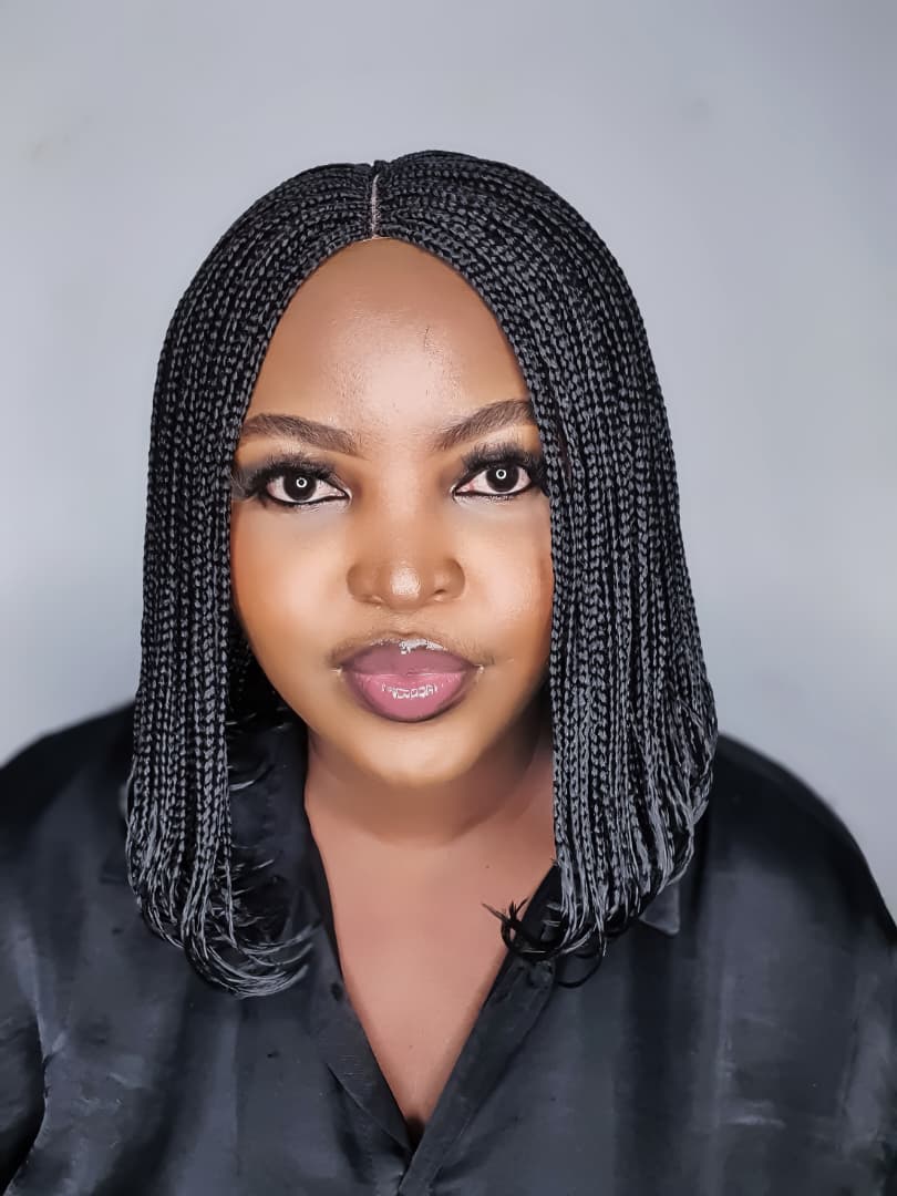 Woman wearing a colour 2 black bob braided lace closure wig with centre part