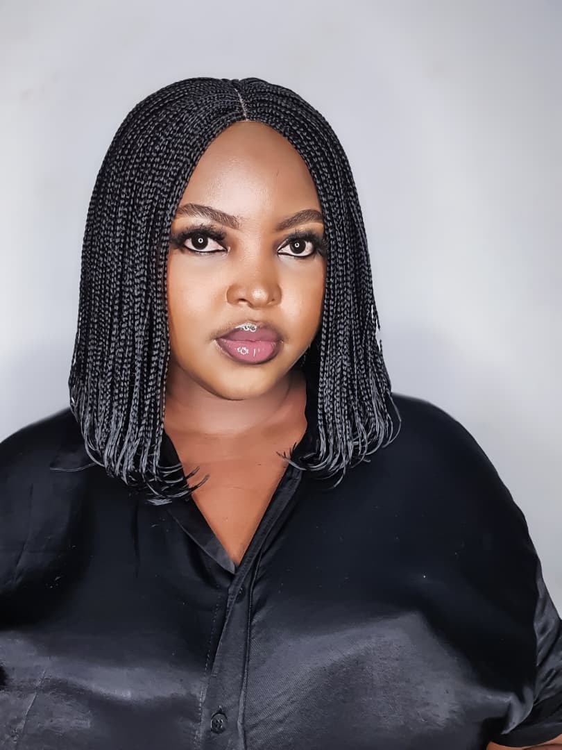 Colour 2 black bob braided wig worn by model, centre-part front view