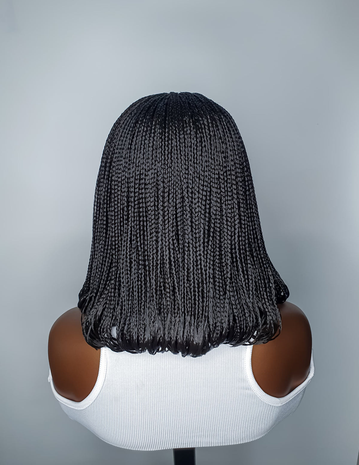 Back view of colour 2 black bob braided wig with curled ends