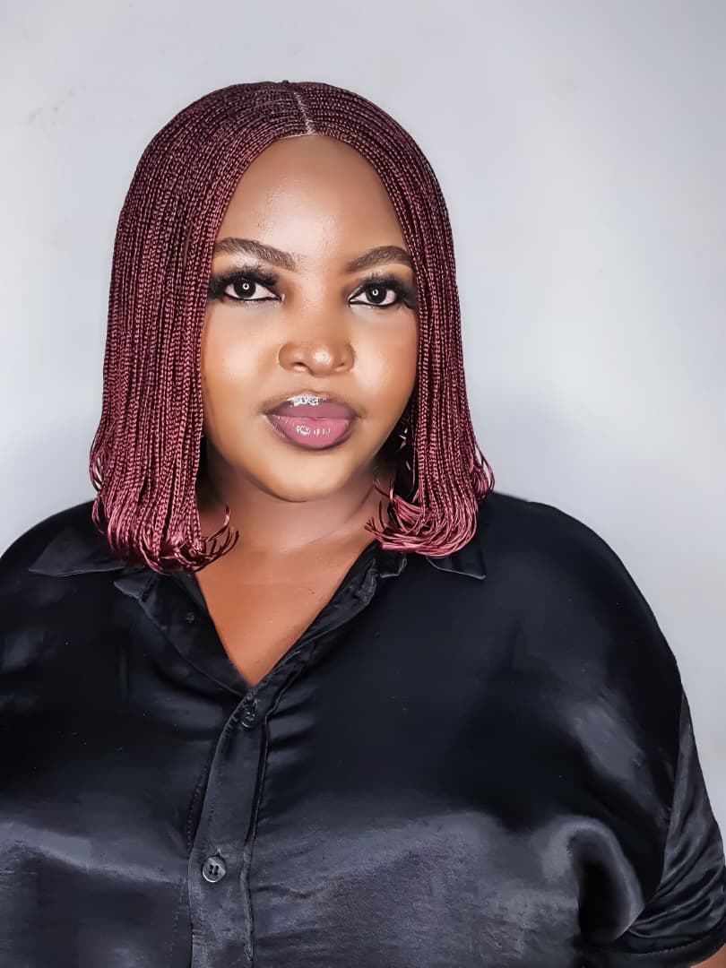 Woman wearing burgundy bob braided wig with small braids and curled ends