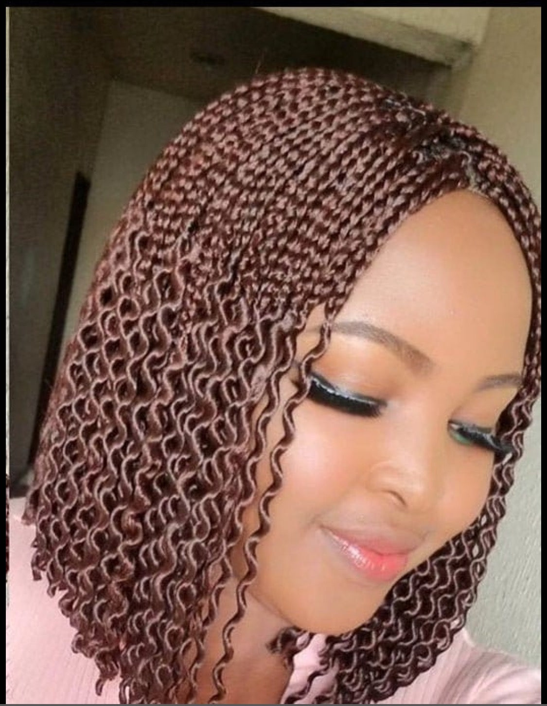 Woman wearing a ready-to-ship colour 35 watermelon braid wig with centre part